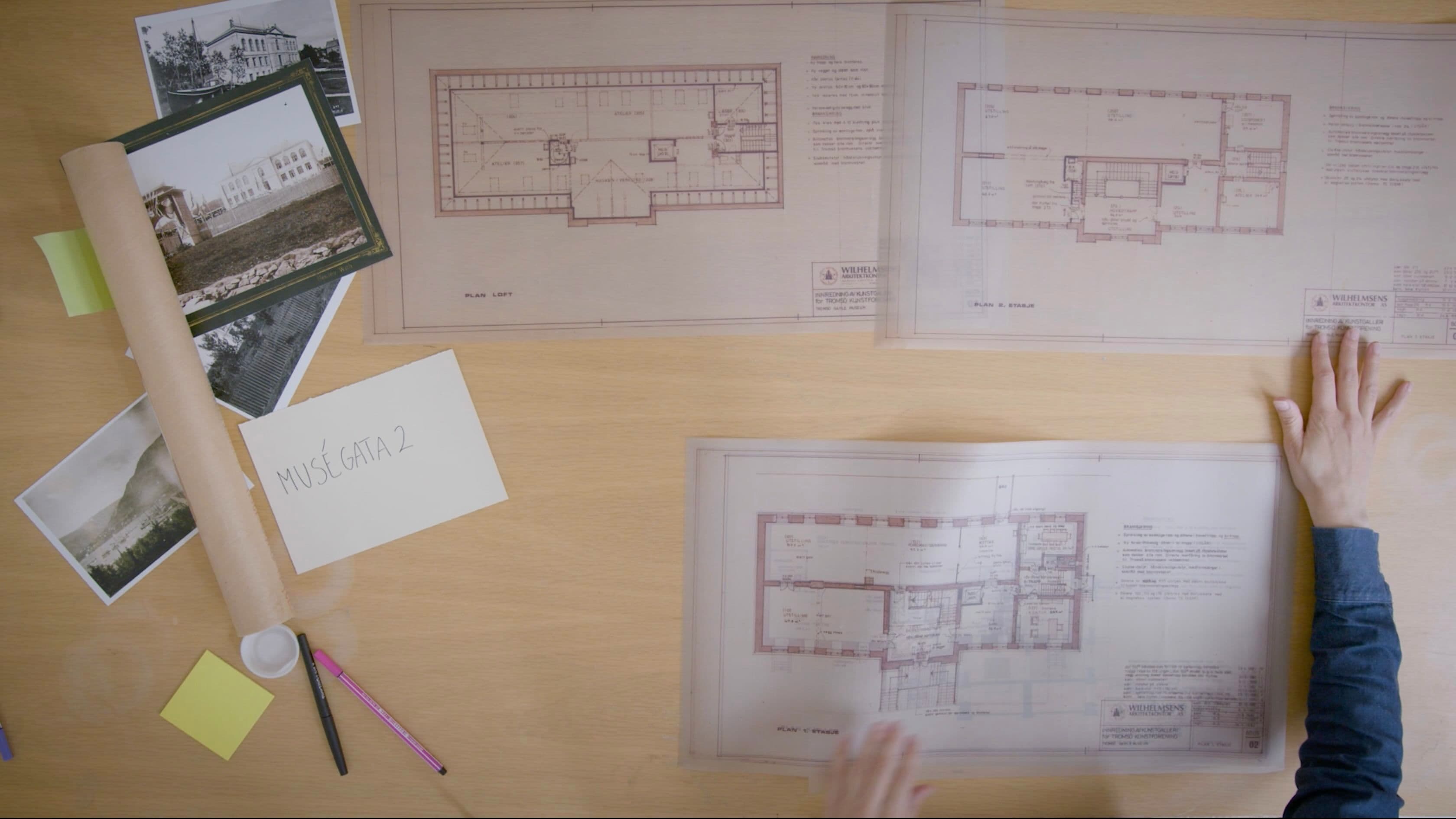 Blueprints for a building lay on a desk